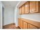 Hallway with cabinets on top and bottom for storage, adjacent to a room with hardwood floors at 3104 Hayden Ct, Las Vegas, NV 89134