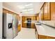 Functional kitchen with stainless steel refrigerator, wood cabinets, and a skylight for ample natural light at 3104 Hayden Ct, Las Vegas, NV 89134
