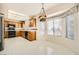 Charming eat-in kitchen with wood cabinets, modern appliances, and a breakfast nook with large windows at 3104 Hayden Ct, Las Vegas, NV 89134