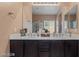 Dual sink vanity bathroom with plenty of counter space and a large mirror at 33 Via Di Mello, Henderson, NV 89011