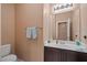 Half bathroom featuring a modern sink, mirror, and towel rack with neutral finishes at 33 Via Di Mello, Henderson, NV 89011