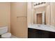 Powder room with a dark cabinet vanity, white countertop, and modern lighting at 33 Via Di Mello, Henderson, NV 89011
