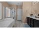 Bright bathroom featuring a separate shower, soaking tub, and dual sinks at 33 Via Di Mello, Henderson, NV 89011
