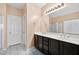 Bathroom featuring a double sink vanity and a glass enclosed shower at 33 Via Di Mello, Henderson, NV 89011