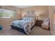 Comfortable bedroom with a queen bed, large window, and decorative artwork at 33 Via Di Mello, Henderson, NV 89011