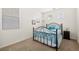 Bright bedroom features a wrought iron bed frame, neutral carpet and stylish decor at 33 Via Di Mello, Henderson, NV 89011