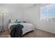 Bright bedroom with a large window providing natural light, plush carpet, and lamps at 33 Via Di Mello, Henderson, NV 89011