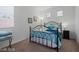 Comfortable bedroom with a wrought iron bed frame and blue decorative pillows and blankets at 33 Via Di Mello, Henderson, NV 89011
