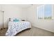 Inviting bedroom with a floral bedspread, neutral carpet and a large window with blinds at 33 Via Di Mello, Henderson, NV 89011