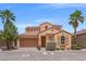 Charming stucco home with a two-car garage, tile roof, and low maintenance desert landscaping at 33 Via Di Mello, Henderson, NV 89011