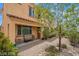 Home's welcoming front yard with desert landscaping, a covered porch, and outdoor seating at 33 Via Di Mello, Henderson, NV 89011