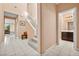 View of the foyer showcasing the staircase, tile floors and access to a half bathroom at 33 Via Di Mello, Henderson, NV 89011