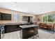 Spacious kitchen with granite countertops, an island with seating, and a view to dining area at 33 Via Di Mello, Henderson, NV 89011