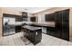 Modern kitchen featuring stainless steel appliances, granite countertops, and dark wood cabinetry at 33 Via Di Mello, Henderson, NV 89011