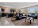 Open-concept living room with a cozy carpet, neutral colors, and lots of natural light at 33 Via Di Mello, Henderson, NV 89011