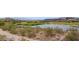 Scenic view of a serene pond and lush green golf course in a residential community at 33 Via Di Mello, Henderson, NV 89011
