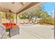 Expansive backyard features a covered patio, lounge seating, and mature trees for shade and privacy at 366 Rancho La Costa St, Las Vegas, NV 89138
