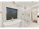 Luxury bathroom with freestanding tub, glass enclosed shower with gold fixtures, and designer window at 366 Rancho La Costa St, Las Vegas, NV 89138
