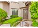 Charming front entrance with lush landscaping, a small fountain, and a gate leading to the front door at 366 Rancho La Costa St, Las Vegas, NV 89138