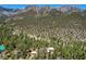 Overhead shot of a secluded estate nestled among lush trees, boasting incredible mountain views at 4162 Matterhorn Way, Las Vegas, NV 89124
