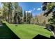 Expansive backyard featuring lush landscaping and mountain scenery at 4162 Matterhorn Way, Las Vegas, NV 89124