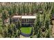Home featuring artifical turf and balconies set among mature pine trees at 4162 Matterhorn Way, Las Vegas, NV 89124