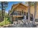 Beautiful backyard with a deck, black iron fence and mature trees at 4162 Matterhorn Way, Las Vegas, NV 89124