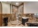 Stylish bathroom with marble tile, glass shower and modern fixtures at 4162 Matterhorn Way, Las Vegas, NV 89124