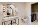 Modern bathroom featuring a marble vanity, decorative mirror, and a convenient adjacent laundry area at 4162 Matterhorn Way, Las Vegas, NV 89124