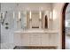 Bright bathroom featuring a double vanity with marble countertop and white cabinets at 4162 Matterhorn Way, Las Vegas, NV 89124