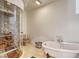 Primary bathroom features a stand alone tub, glass enclosed shower, and natural stone tile floors at 4162 Matterhorn Way, Las Vegas, NV 89124
