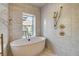 Bright bathroom featuring a soaking tub and a shower with mountain views at 4162 Matterhorn Way, Las Vegas, NV 89124