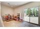 Bright bonus room features neutral walls, tile floors, shelving units, and a sliding glass door to the backyard at 4162 Matterhorn Way, Las Vegas, NV 89124