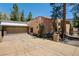 Unique home with stone accents and a three car garage, surrounded by mature trees at 4162 Matterhorn Way, Las Vegas, NV 89124