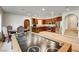 Large game room with air hockey table and a kitchen area with stainless steel appliances and custom wood cabinets at 4162 Matterhorn Way, Las Vegas, NV 89124