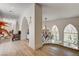 Hallway with arched windows, hardwood floors, and decorative lighting at 4162 Matterhorn Way, Las Vegas, NV 89124