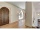 Hallway featuring an arched doorway and wall sconces at 4162 Matterhorn Way, Las Vegas, NV 89124