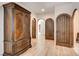Hallway featuring hardwood floors, arched doorways and a large armoire at 4162 Matterhorn Way, Las Vegas, NV 89124