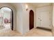 Hallway featuring arched doorways, tile flooring, with a view into a playroom at 4162 Matterhorn Way, Las Vegas, NV 89124