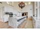 Bright, open kitchen featuring a marble waterfall island, stainless appliances, and grand chandelier at 4162 Matterhorn Way, Las Vegas, NV 89124