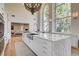 Gourmet kitchen features marble countertops, a large island with seating, and expansive windows with views at 4162 Matterhorn Way, Las Vegas, NV 89124