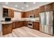 Gourmet kitchen featuring custom wood cabinets, granite countertops, and stainless steel appliances at 4162 Matterhorn Way, Las Vegas, NV 89124
