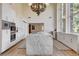 Modern kitchen featuring marble countertops, white cabinetry, and stainless steel appliances at 4162 Matterhorn Way, Las Vegas, NV 89124