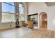 Bright living room features hardwood floors, a fireplace, a statue, and grand windows with mountain views at 4162 Matterhorn Way, Las Vegas, NV 89124