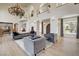 Spacious living room featuring high ceilings, an ornate chandelier, and stylish furnishings at 4162 Matterhorn Way, Las Vegas, NV 89124
