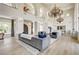 Spacious living room featuring high ceilings, chandelier, and open kitchen layout at 4162 Matterhorn Way, Las Vegas, NV 89124
