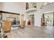 Grand living room with soaring ceilings, a fireplace, hardwood floors, and large windows with views at 4162 Matterhorn Way, Las Vegas, NV 89124
