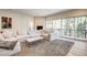Inviting living room with a large sectional sofa, fireplace, and floor-to-ceiling windows offering natural views at 4162 Matterhorn Way, Las Vegas, NV 89124