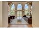 Living room with expansive windows offering scenic mountain views and decorative chandeliers at 4162 Matterhorn Way, Las Vegas, NV 89124