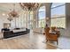 Spacious living room boasts hardwood floors, high ceilings, large windows, and a decorative chandelier at 4162 Matterhorn Way, Las Vegas, NV 89124